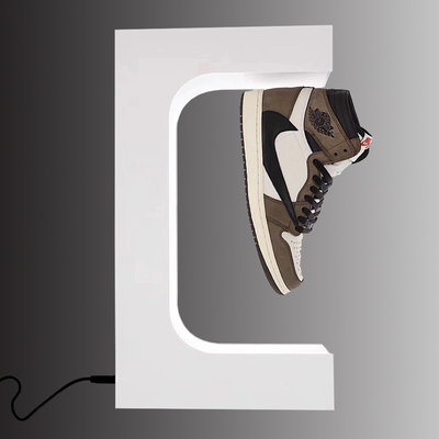 Die Mode, die magnetischen sich hin- und herbewegenden SchuhAusstellungsstand frei schweben und das Schaufenster für die Schuhe, die fantastisch sind, trennen die weiße SchuhDisplay-Unit