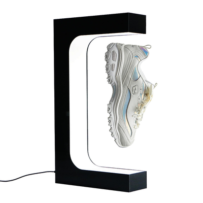 Die Mode, die magnetischen sich hin- und herbewegenden SchuhAusstellungsstand frei schweben und das Schaufenster für die Schuhe, die fantastisch sind, trennen die weiße SchuhDisplay-Unit